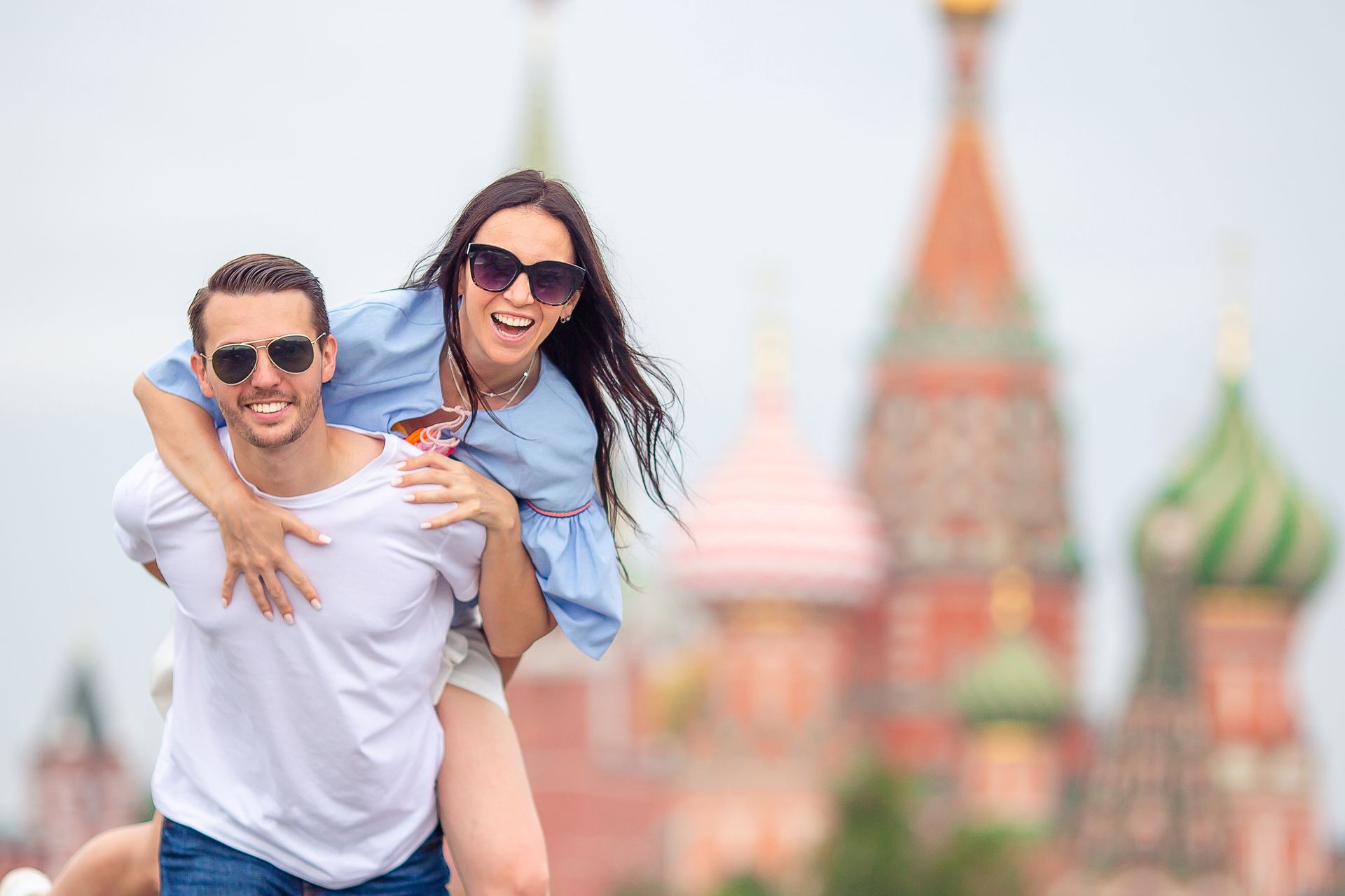 Young dating couple in love walking in city. Portrait of a happy romantic couple outdoors in Moscow city